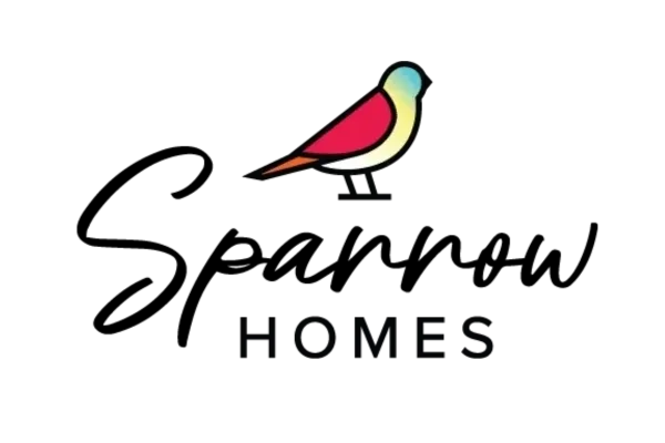 A bird is sitting on the ground in front of a black background.